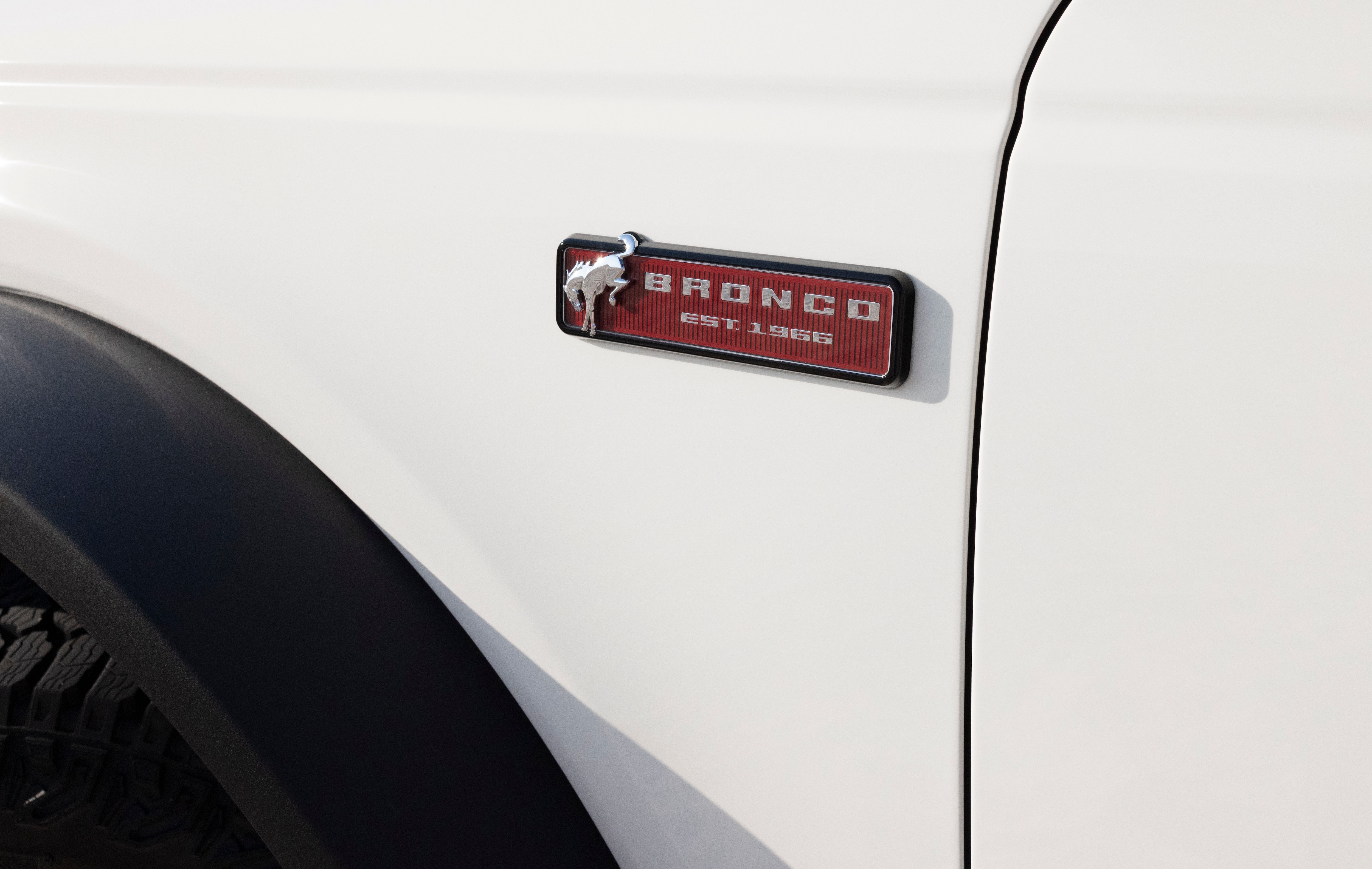 2026 Ford Bronco 60th Anniversary Package details shown. Small red plate near front tire reads "Bronco, 1966"